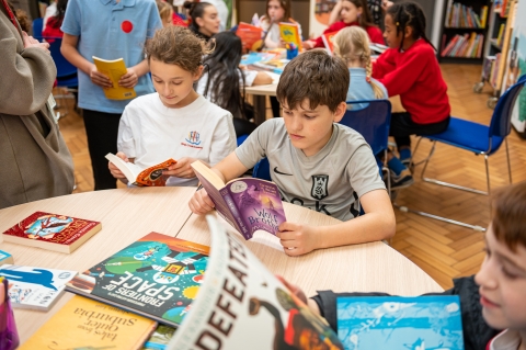 children reading books at table