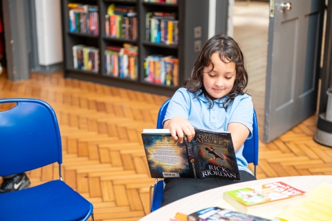 Girl seated reading book