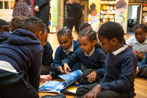 Children on the floor reading a book 