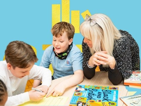 Two boys writing with teacher