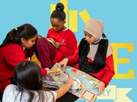 Girls reading a picture book with blue background