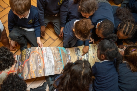 Group of children looking at a picture book